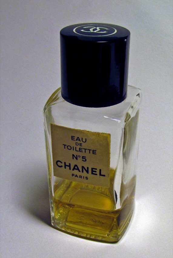 A real Chanel No. 5 perfume bottle photographed against a neutral background